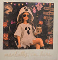 Barbie in a ghost costume with Halloween decorations